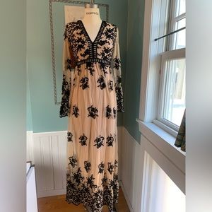 Floor length long sleeve black lace and nude mesh gown